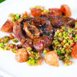 Pan-fried leg of lamb steaks served with pea "salsa" and fried new potatoes.