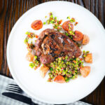Pan fried garlic and rosemary lamb leg steaks with pea "salsa" and fried new potatoes.