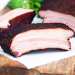 Meaty smoked BBQ pork ribs cut open to show juicy meat texture.