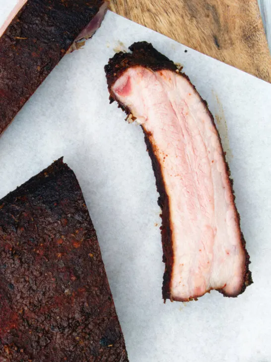 Overhead close-up meaty smoked BBQ pork ribs cut open to show juicy meat texture.