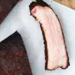 Overhead close-up meaty smoked BBQ pork ribs cut open to show juicy meat texture.