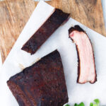 Overhead meaty smoked BBQ pork ribs cut open to show juicy meat texture.