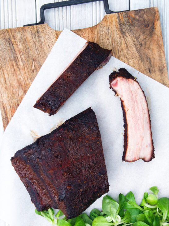 Overhead meaty smoked BBQ pork ribs cut open to show juicy meat texture.