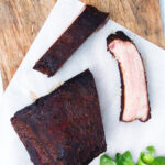 Overhead meaty smoked BBQ pork ribs cut open to show juicy meat texture.