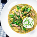 Overhead Thai green chicken curry with mangetout and baby corn.