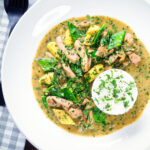 Overhead Thai green chicken curry with mangetout and baby corn.