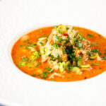 Spicy chicken and prawn soup with Thai influences.