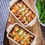 Overhead individual vegan mushroom hotpots topped with potatoes (Lancashire) style.
