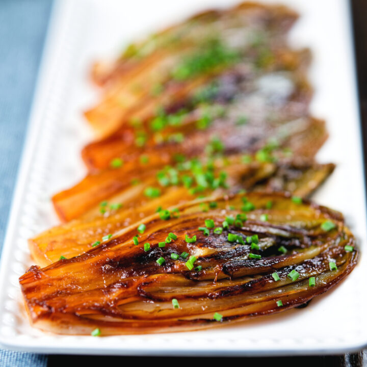 Braised White Chicory or Belgian Endive served with snipped chives.
