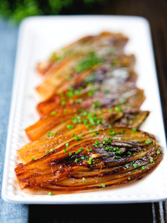 Close-Up Braised White Chicory or Belgian Endive with Snipped Chives.