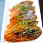 Close-Up Braised White Chicory or Belgian Endive with Snipped Chives.