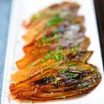 Close-Up Braised White Chicory or Belgian Endive with Snipped Chives.
