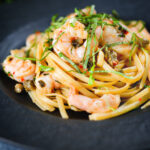 Garlic chilli prawn (shrimp) linguine with fried capers and basil.