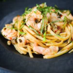 Garlic chilli prawn (shrimp) linguine with fried capers and basil.