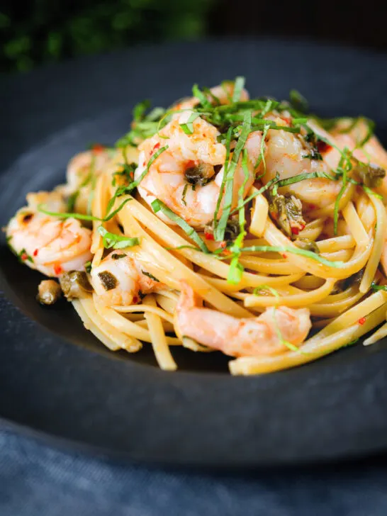 Garlic chilli prawn (shrimp) linguine with fried capers and basil.