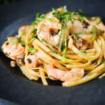 Garlic chilli prawn (shrimp) linguine with fried capers and basil.