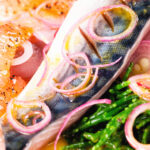 Close-up salt cured mackerel fillet salad with grapefruit, samphire and toasted rye bread.