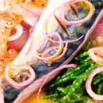 Close-up salt cured mackerel fillet salad with grapefruit, samphire and toasted rye bread.