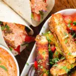 Overhead close-up of crispy halloumi cheese wraps with a harissa and yoghurt sauce.