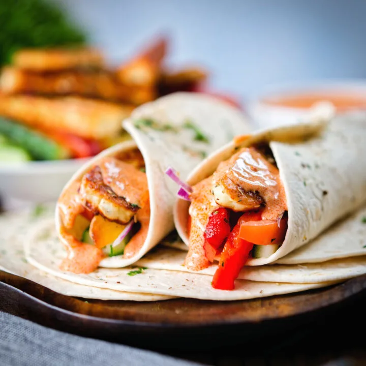 Halloumi cheese salad wraps with roasted peppers and a sweet harissa yoghurt sauce.