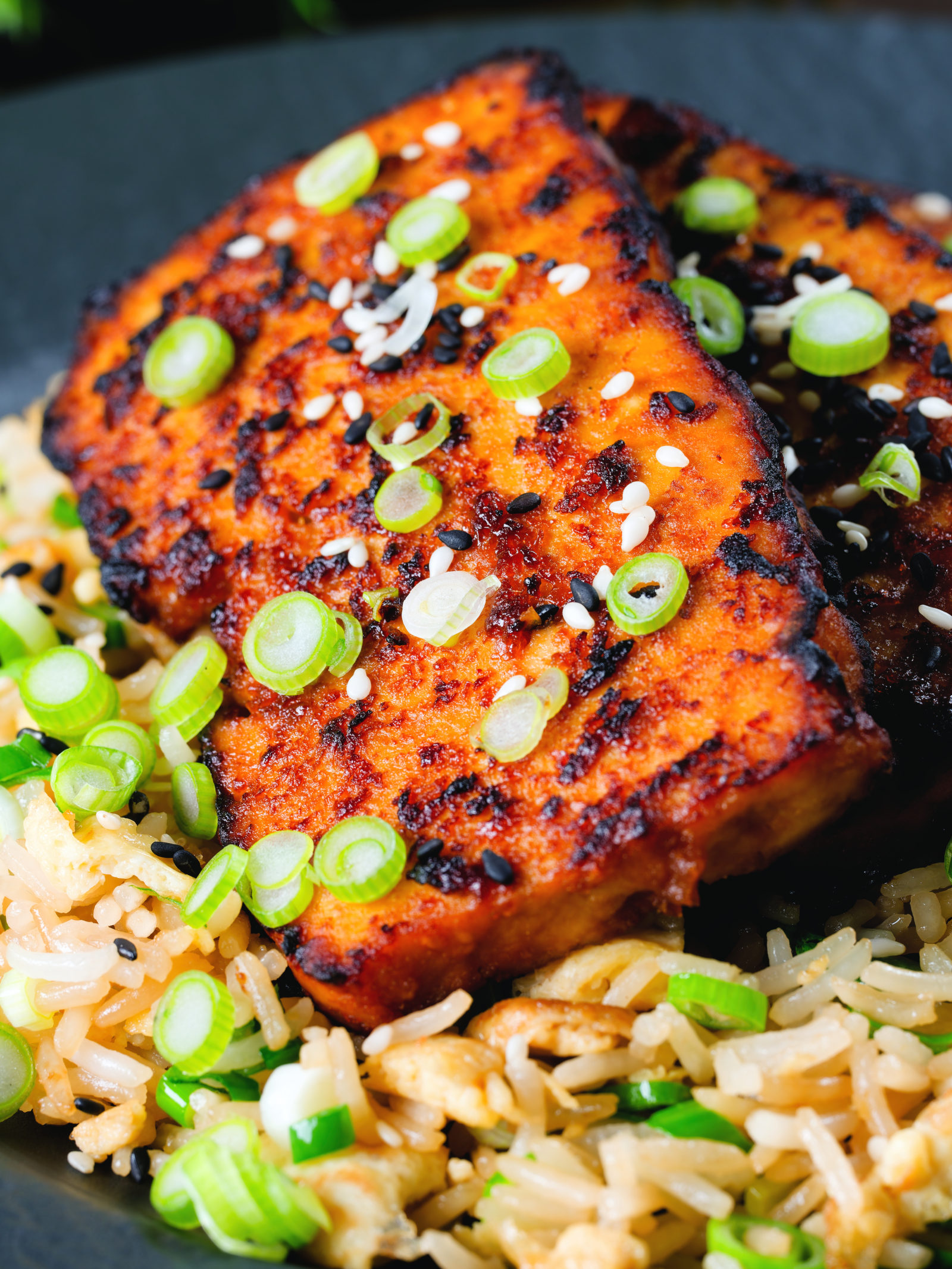 Close-up honey and miso glazed tofu served with egg fried rice.