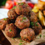 Greek meatballs, keftedes served with a yoghurt dip, salad and potato wedges.
