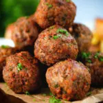 Close up fried Greek meatballs or keftedes garnished with parsley.
