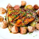 Maple syrup and Worcestershire sauce glazed chicken breast with fried potatoes and braised chicory.