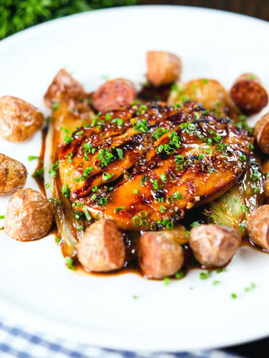 Maple syrup and Worcestershire sauce glazed chicken breast with fried potatoes and braised chicory.