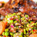 Close-up minted pea salsa or salad with capers, tomatoes chilli and red onion.