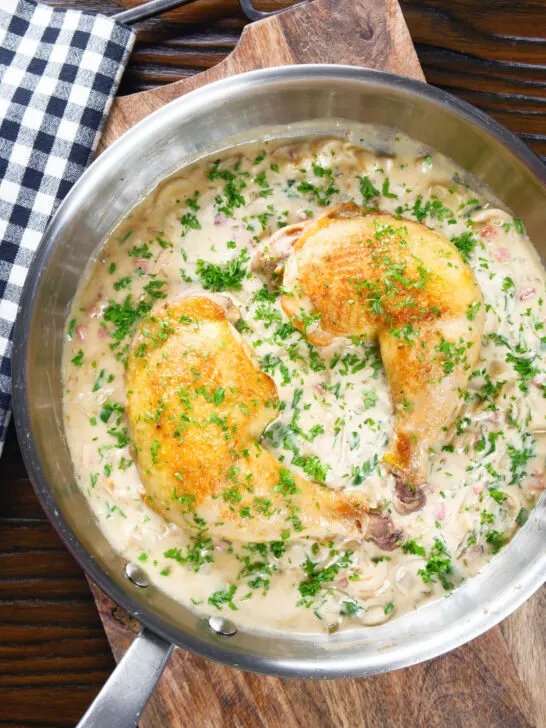 Overhead chicken Normandy in a cider and mustard sauce in a pan.