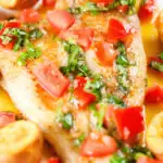 Close-up pan fried brill fish served with sauce vierge and fried potatoes.
