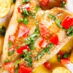 Close-up overhead pan fried brill fish served with sauce vierge and fried potatoes.