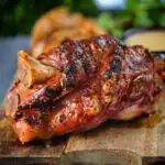 Crispy roast ham hock glazed with honey and mustard served with potato wedges and cider sauce.