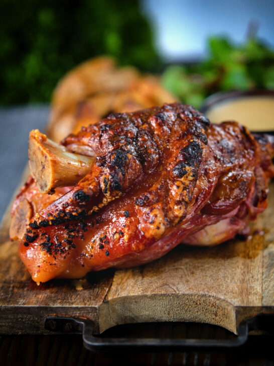 Crispy roast ham hock glazed with honey and mustard served with potato wedges and cider sauce.