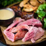 Roast ham hock meat served with potato wedges and cider sauce.