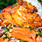 Close-up tandoori cod fish with raita and a mung bean salad.