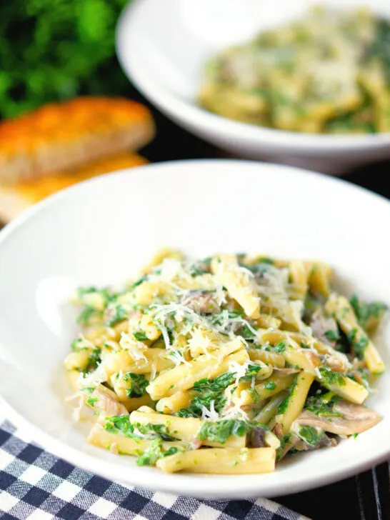 Spinach and mushroom pasta with parmesan cheese and garlic bread.