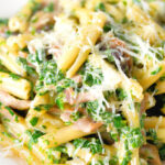 Close-up spinach and mushroom casarecce pasta with parmesan cheese.