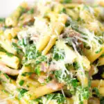 Close-up spinach and mushroom casarecce pasta with parmesan cheese.