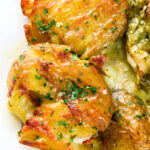 Overhead close-up crispy roasted crushed (smashed) new potatoes.