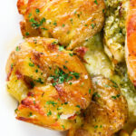 Overhead close-up crispy roasted crushed (smashed) new potatoes.