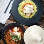 Overhead flaked cod fish tagine served with buttered herby couscous.