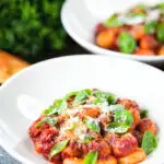 Gnocchi in a rich red wine and tomato sauce served with basil and Parmesan cheese.