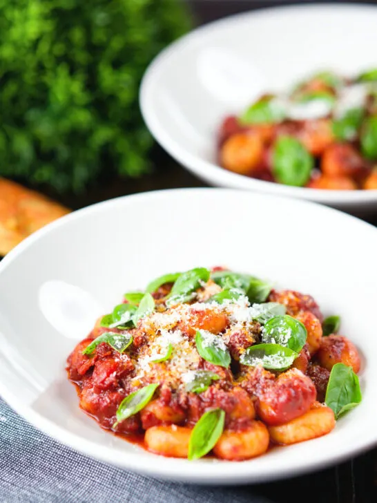 Gnocchi in a rich red wine and tomato sauce served with basil and Parmesan cheese.
