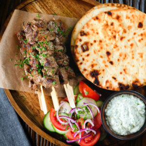 Marinated Greek lamb souvlaki served with tzatziki, salad and flatbreads.