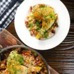 Overhead Spanish-influenced baked chicken and chorizo rice served on a plate.