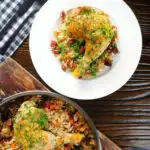 Overhead Spanish-influenced baked chicken and chorizo rice served on a plate.