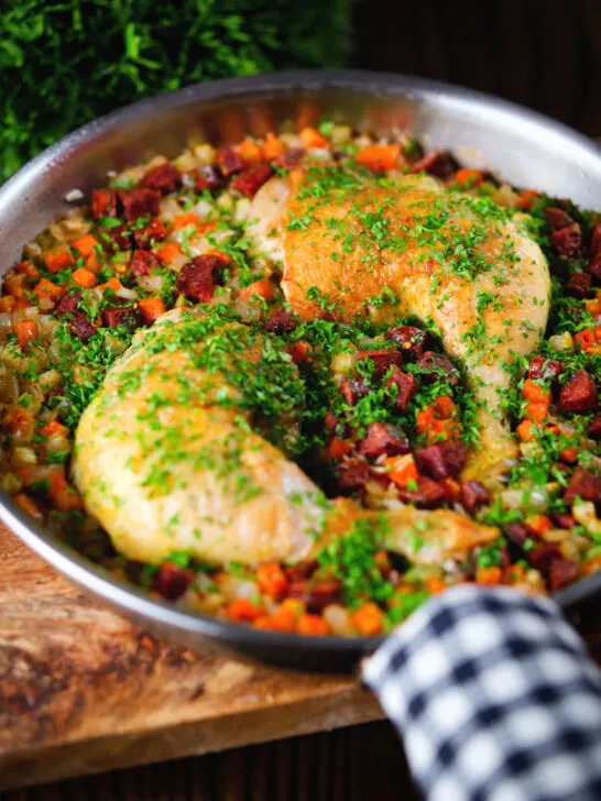 Spanish-influenced baked chicken and chorizo rice in a cooking pan.