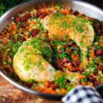 Spanish-influenced baked chicken and chorizo rice in a cooking pan.